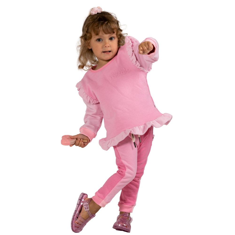 Child wearing a raspberry and candy pink outfit with ruffles on a transparent background