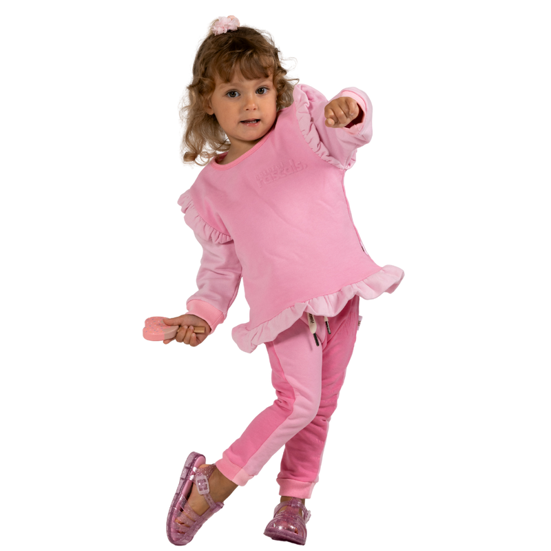 Child wearing a raspberry and candy pink outfit with ruffles on a transparent background