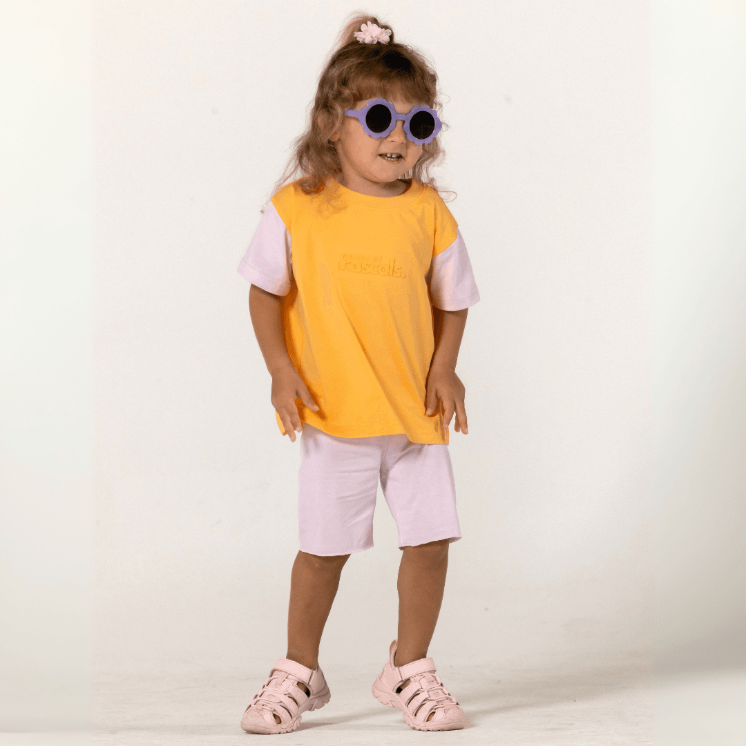 Toddler wearing soft lilac bike shorts and a matching two tone t shirt by Natural Rascals