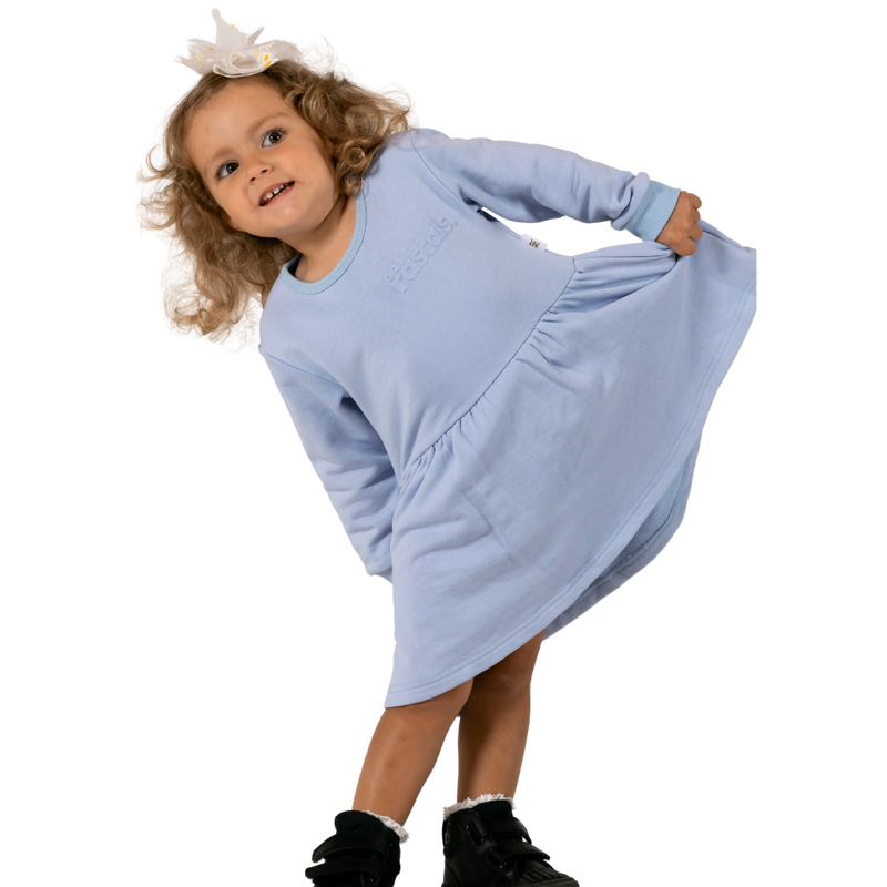 Child wearing a periwinkle lavender spill resistant dress on a transparent background by Natural Rascals