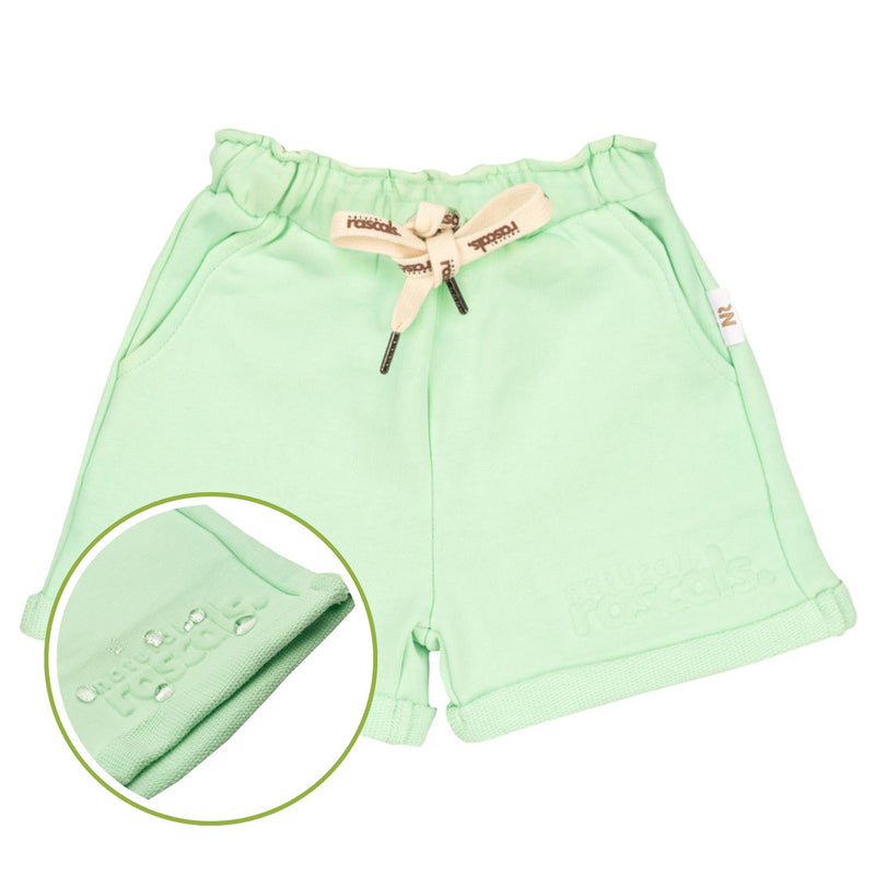 close-up flat lay image of premium mint green shorts featuring a snapshot of the spill resistant technology by Natural Rascals