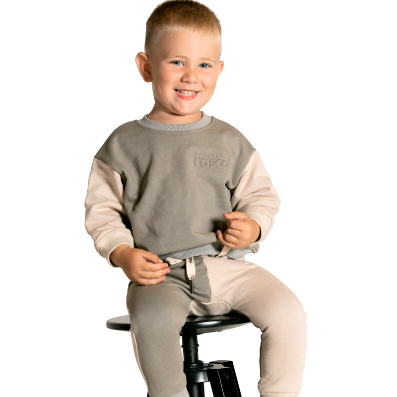 Child wearing earth and oat beige spill-resistant baby toddler sweat jumper by Natural Rascals