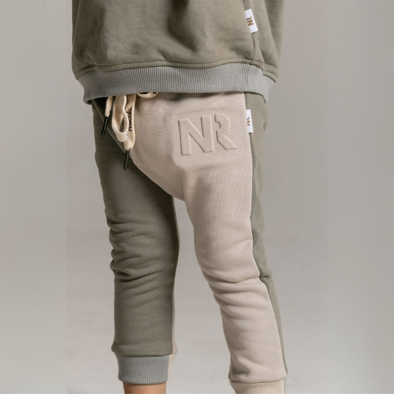 Two-tone jogger pants with 'NR' logo on a plain background spill resistant bottoms by Natural Rascals