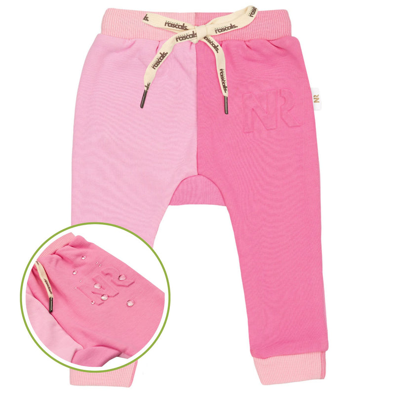 close-up flat lay image of a two tone premium soft sweat jogger in raspberry and candy pink featuring a snapshot of the spill resistant technology by Natural Rascals