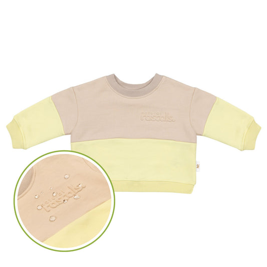 Two children wearing spill resistant sweats in lemonade yellow and oat on a transparent background