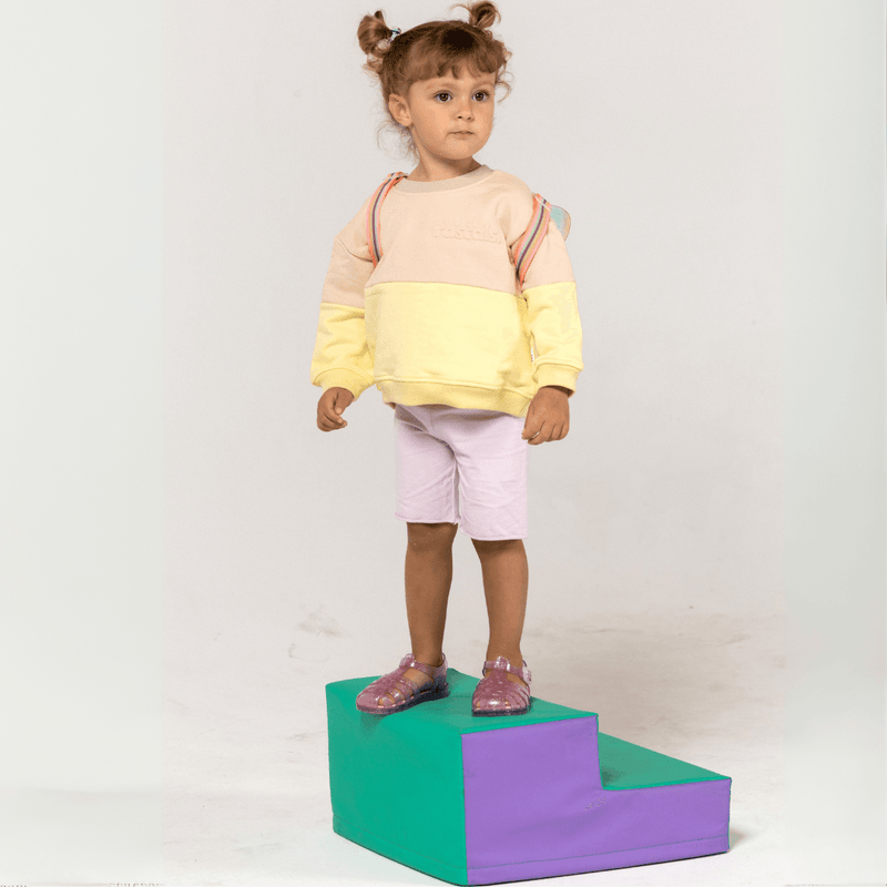 Model shot of Spill-Resistant Baby & Toddler Sweat in Lemonade Yellow & Oat by Natural Rascals