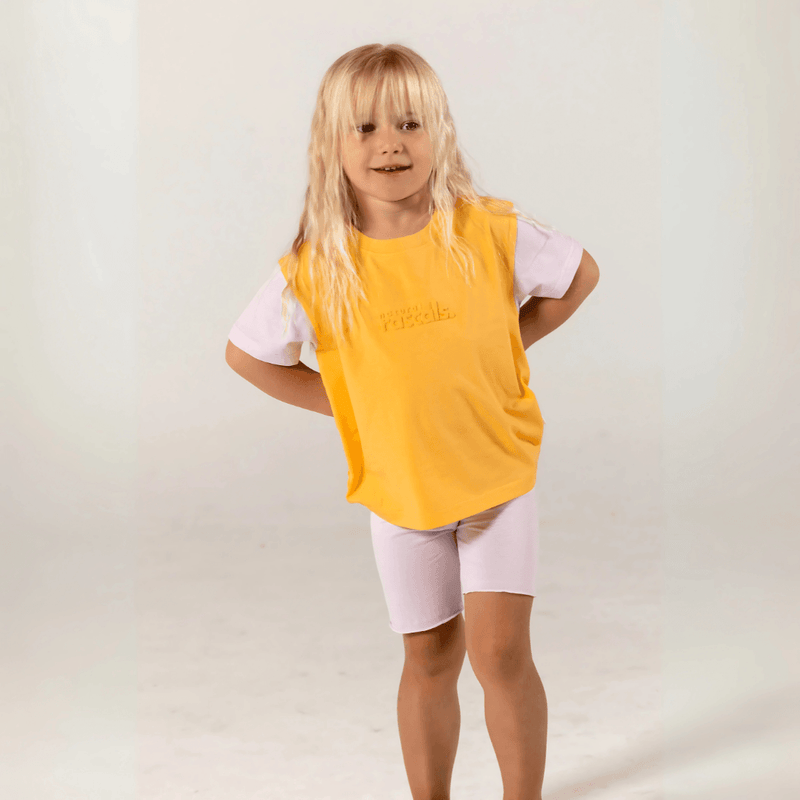 Toddler wearing apricot orange and soft lilac spill-resistant baby tee by Natural Rascals